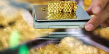 Gold edges up from one-week low as dollar eases off peak