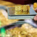 Gold edges up from one-week low as dollar eases off peak